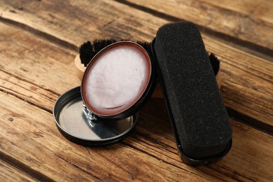Shoe care accessories on wooden background, closeup