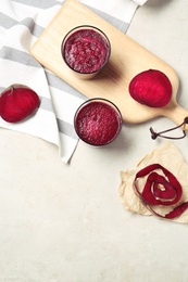 Flat lay composition with beet smoothies on light background. Space for text