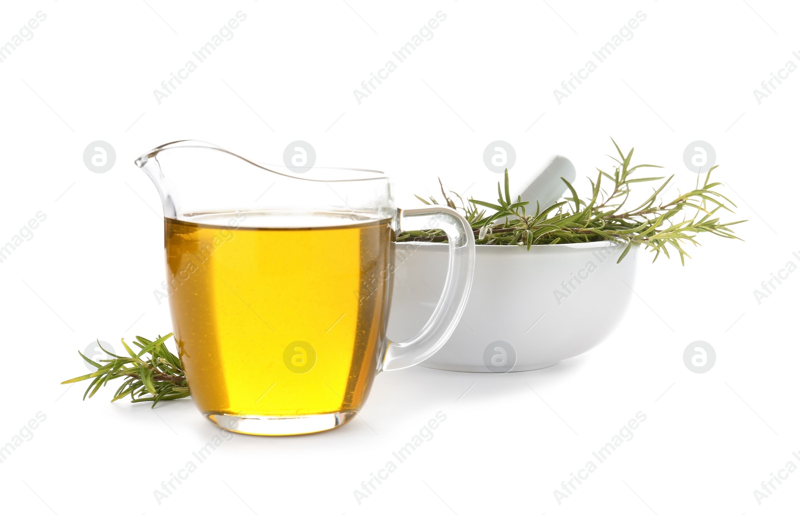 Photo of Jug of oil and fresh herb in mortar on white background