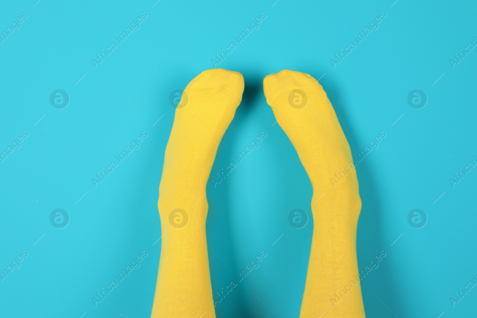 Photo of Woman wearing bright socks on color background