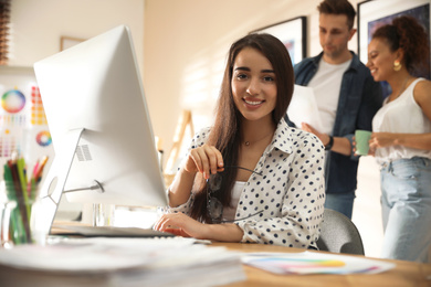 Portrait of happy female designer in office