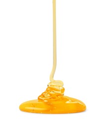 Photo of Pouring tasty natural honey isolated on white