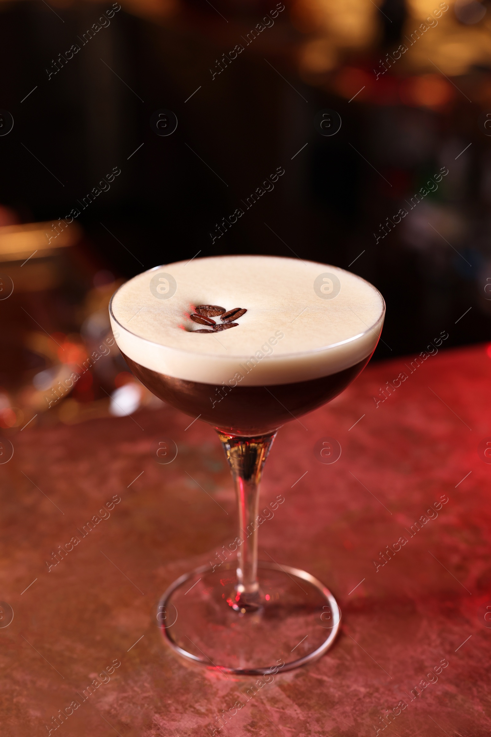 Photo of Glass of delicious Espresso Martini on bar counter. Alcoholic cocktail