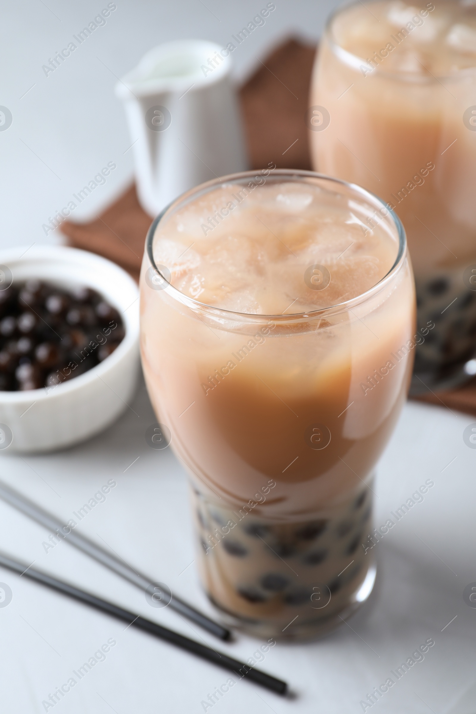 Photo of Bubble milk tea with tapioca balls on light table