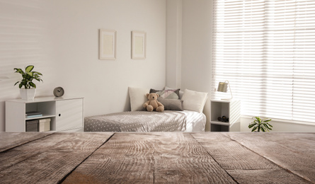 Empty wooden table in baby room interior