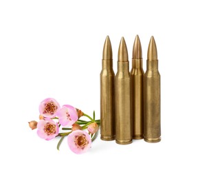 Metal bullets and beautiful flowers isolated on white