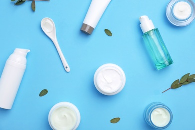 Photo of Flat lay composition with cosmetic products on color background