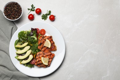 Tasty grilled salmon with avocado, lemon and tomatoes on light grey table, flat lay. Space for text