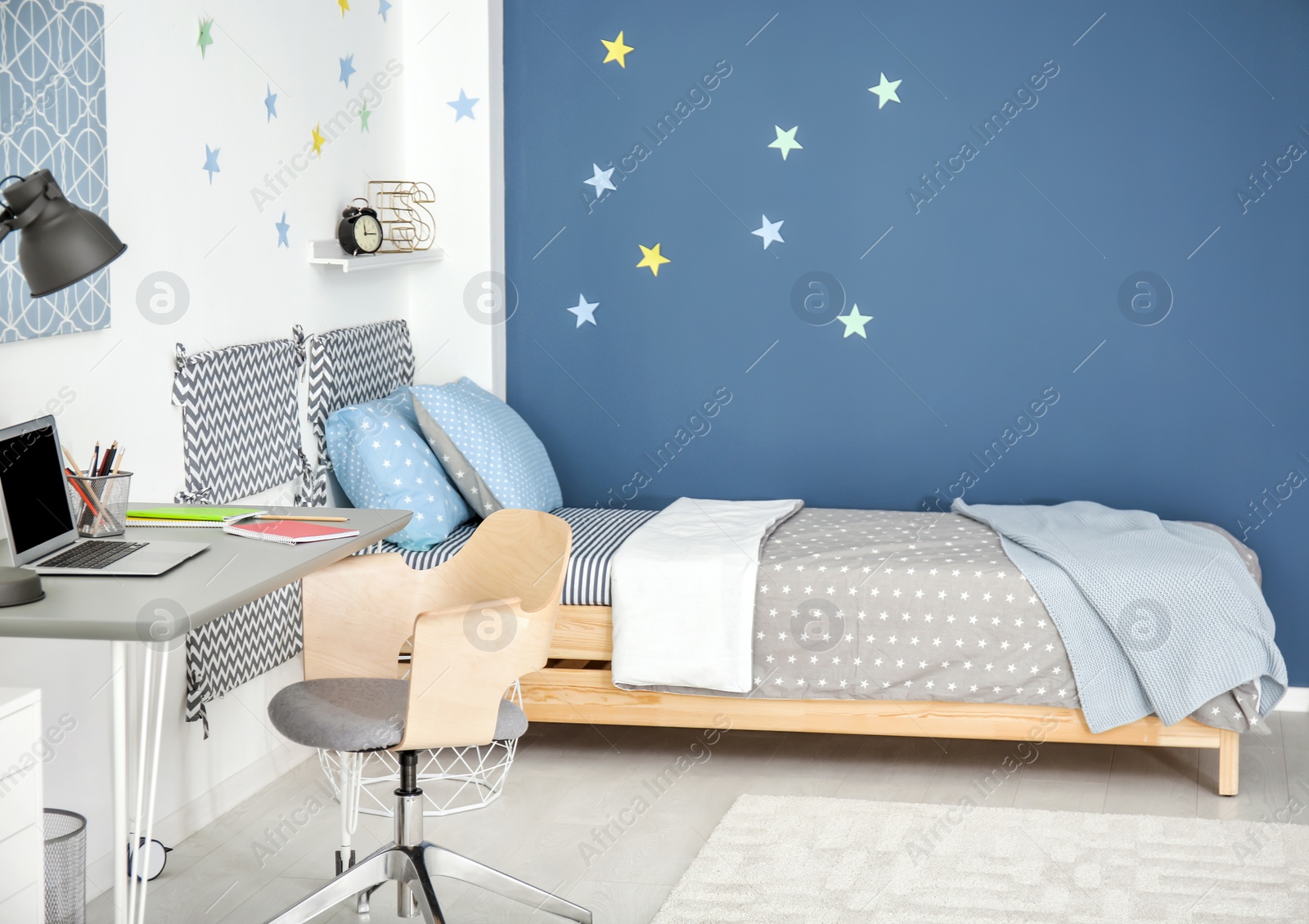 Photo of Modern child room interior with comfortable bed and desk