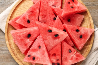 Photo of Delicious fresh watermelon slices on wooden table, top view