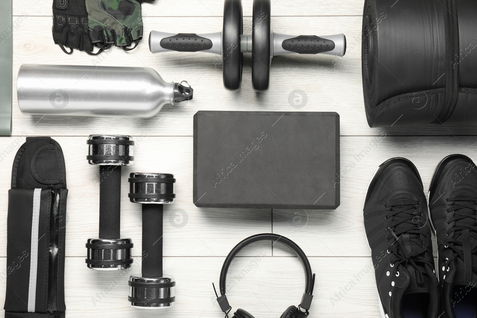 Photo of Different sports equipment on white wooden table, flat lay