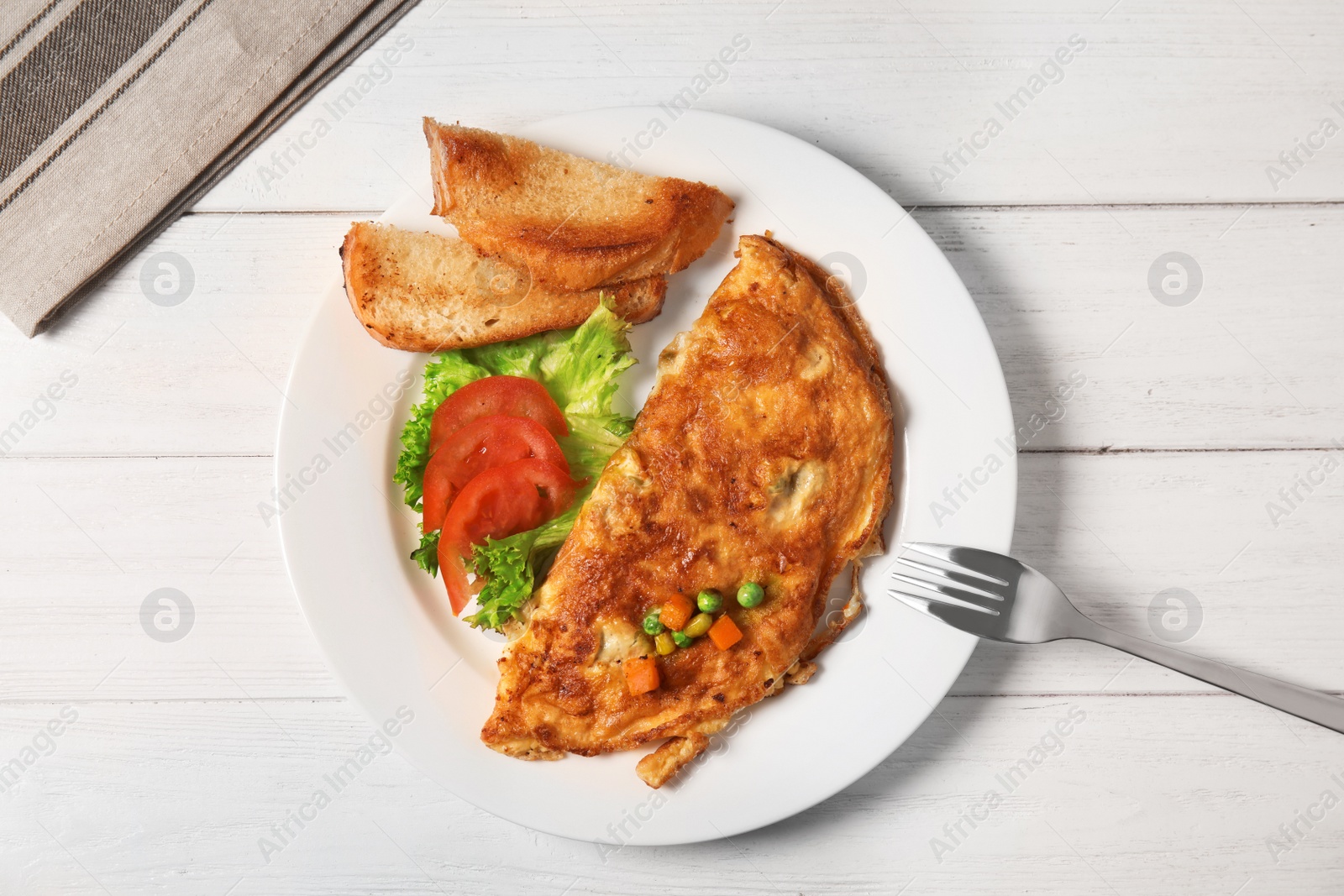 Photo of Omelet with vegetables on plate served for breakfast, top view