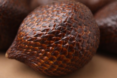 One delicious salak fruit on beige table, closeup