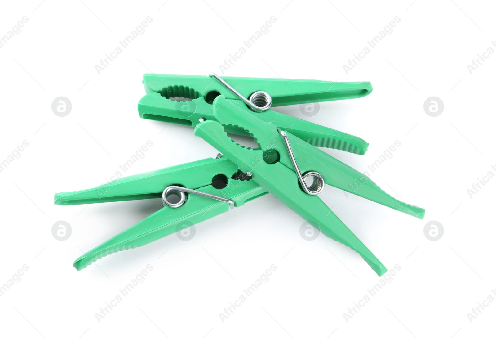 Photo of Bright green plastic clothespins on white background