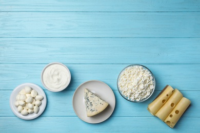 Photo of Fresh dairy products on wooden background, top view