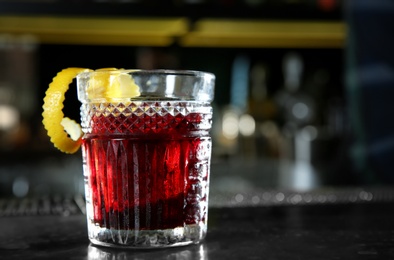 Fresh alcoholic Red Russian cocktail on bar counter. Space for text