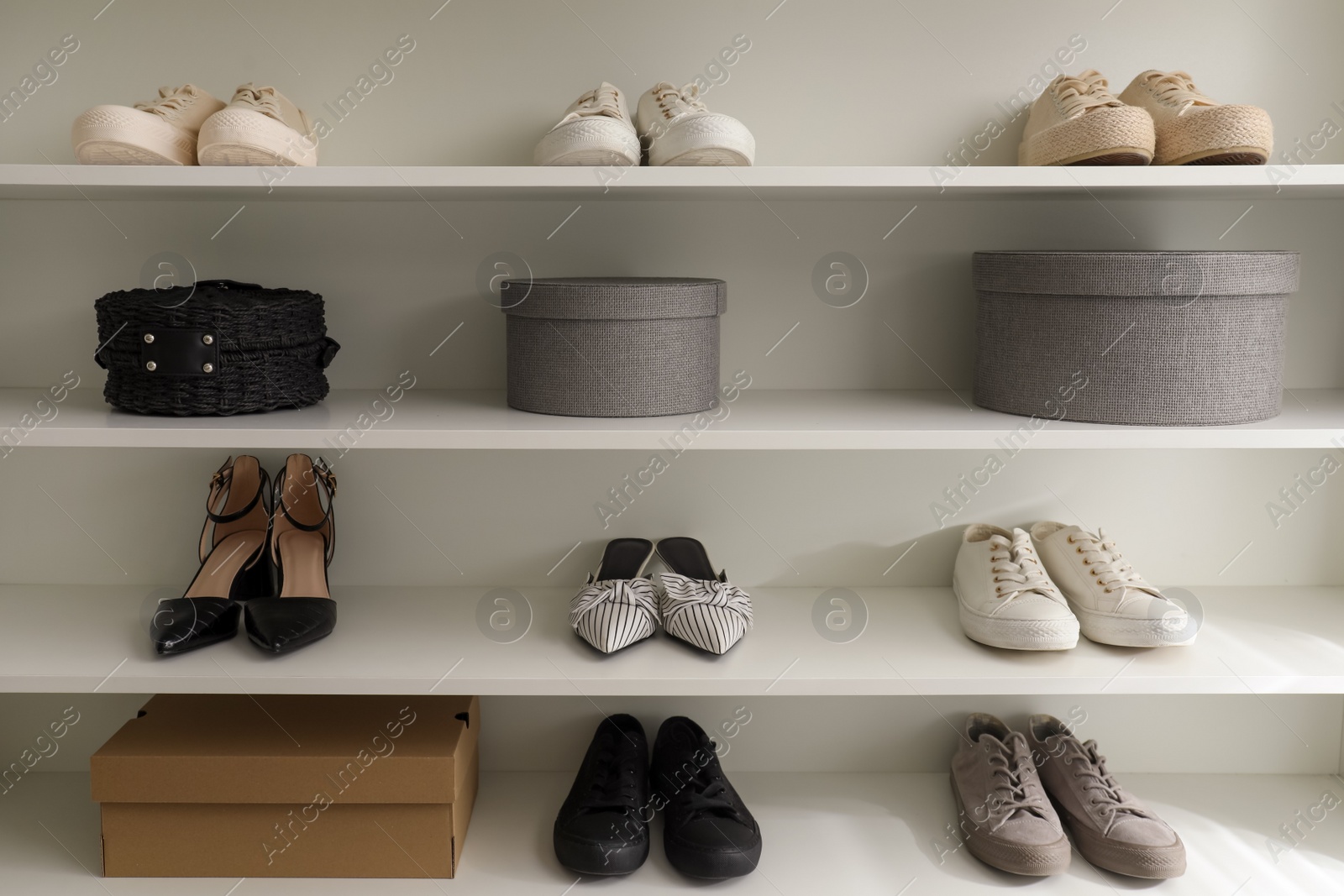 Photo of Storage rack with stylish women's shoes and accessories