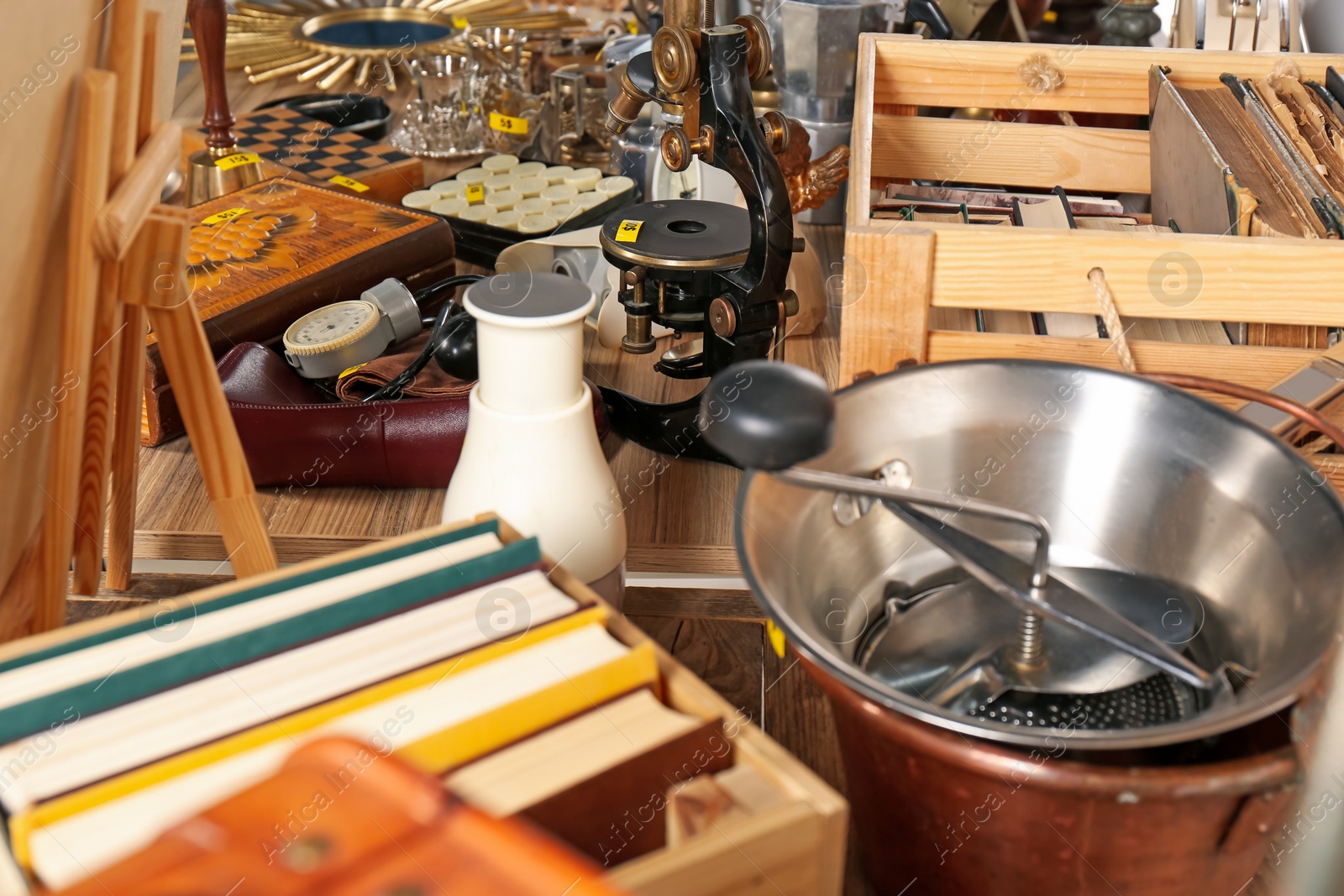 Photo of Many different items on wooden table. Garage sale