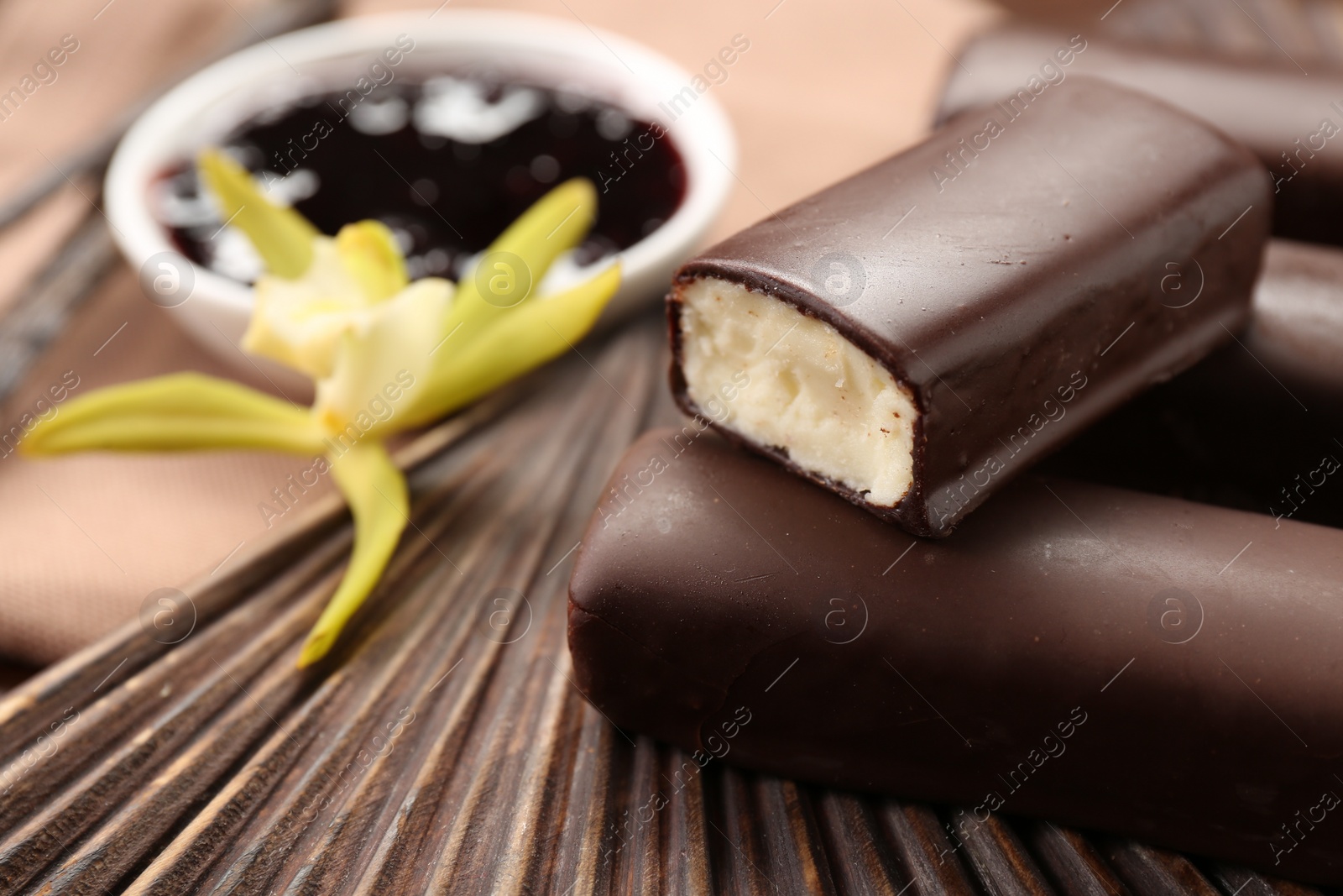 Photo of Glazed vanilla curd cheese bars served on table, closeup