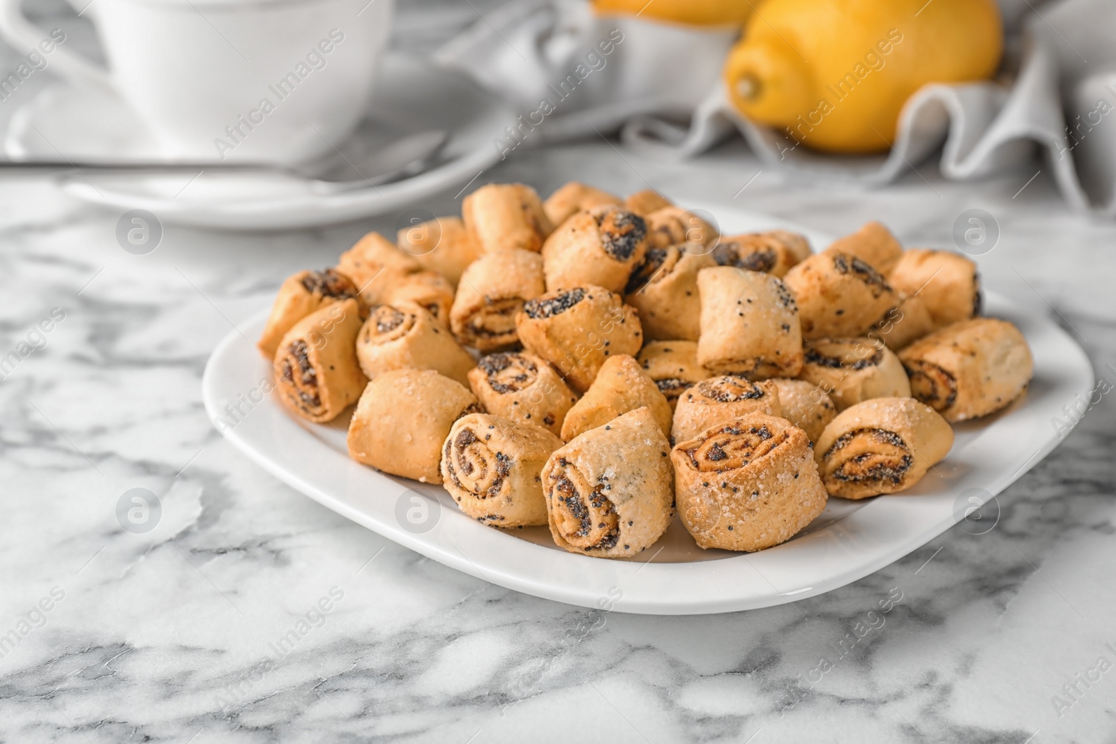 Photo of Tasty sweet cookies with poppy seeds on marble table