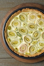 Photo of Tasty leek pie on wooden table, top view