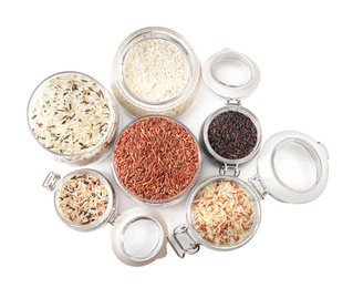 Photo of Brown and polished rice in jars isolated on white, top view