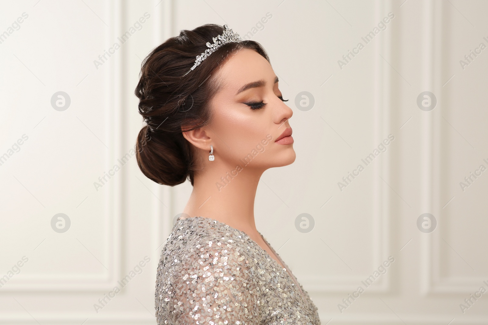 Photo of Beautiful young woman wearing luxurious tiara indoors