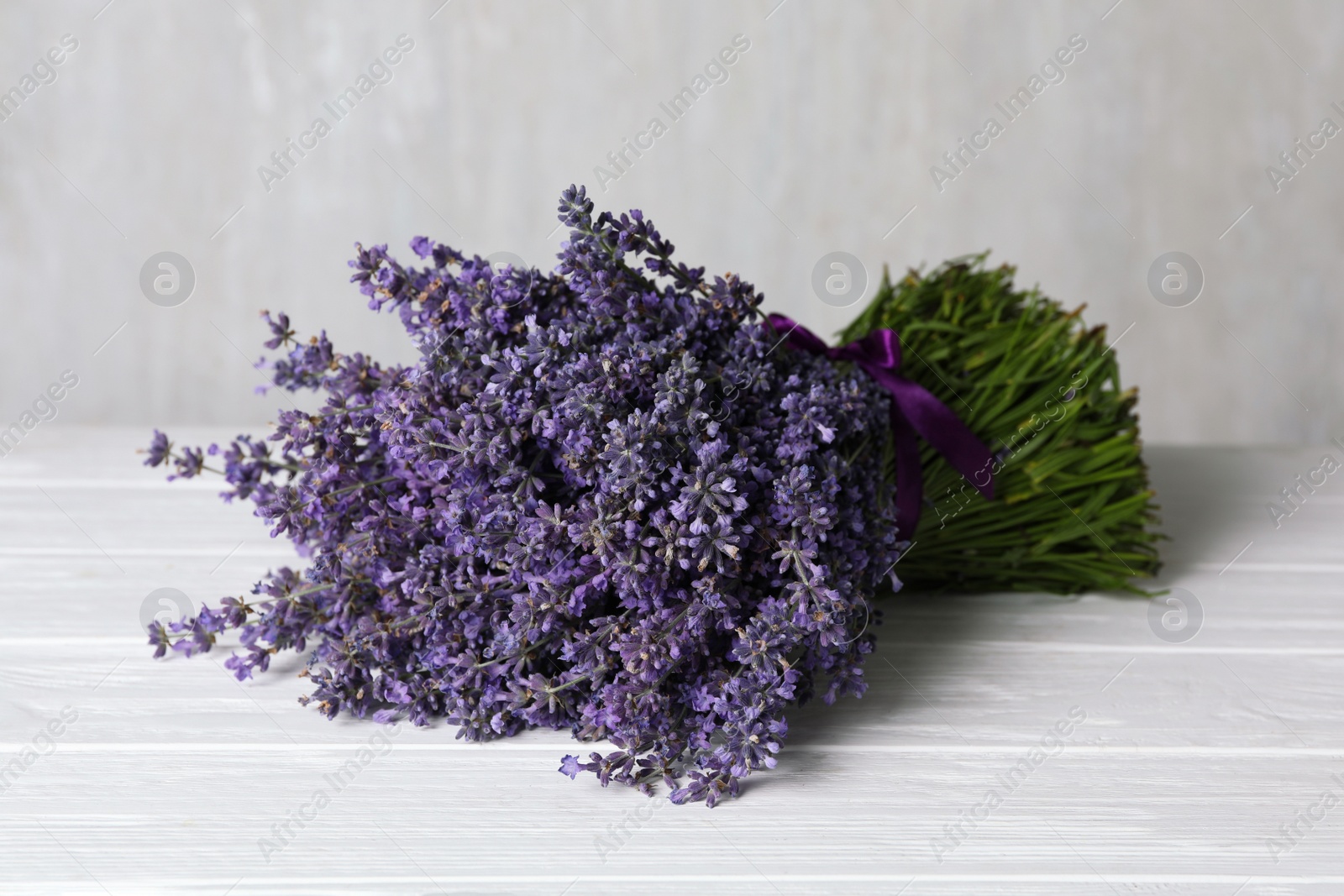 Photo of Beautiful fresh lavender bouquet on white wooden table