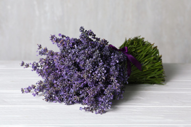 Photo of Beautiful fresh lavender bouquet on white wooden table