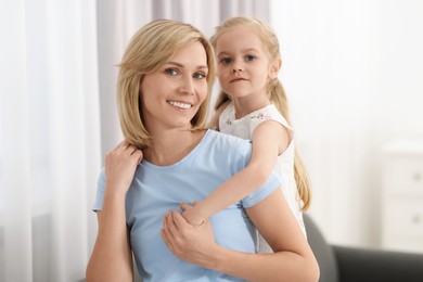Photo of Family portrait of happy mother and daughter at home