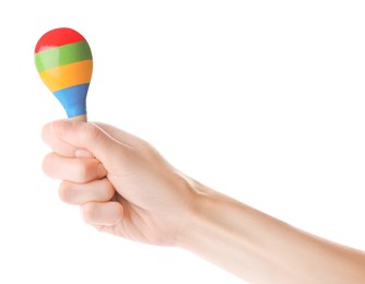 Woman holding colorful maraca on white background, closeup. Musical instrument