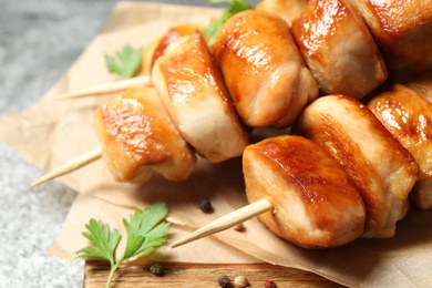 Photo of Delicious chicken shish kebabs with parsley on grey background, closeup