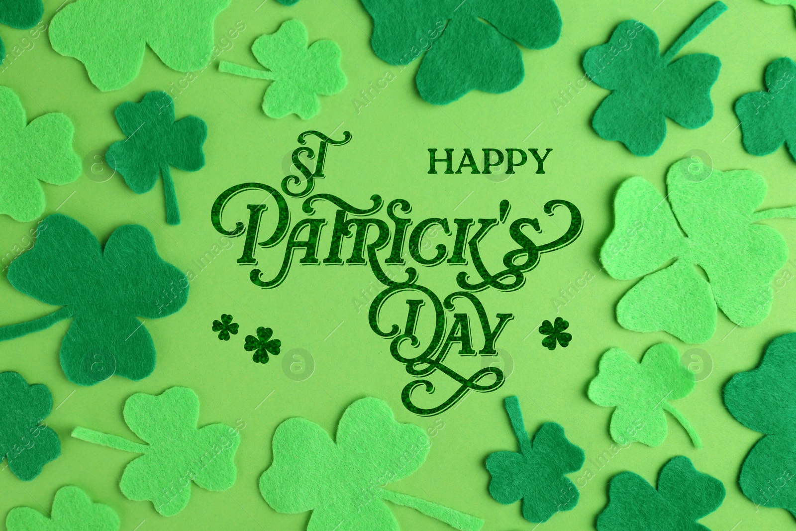 Image of Happy St. Patrick's day card. Decorative clover leaves and text on green background, top view