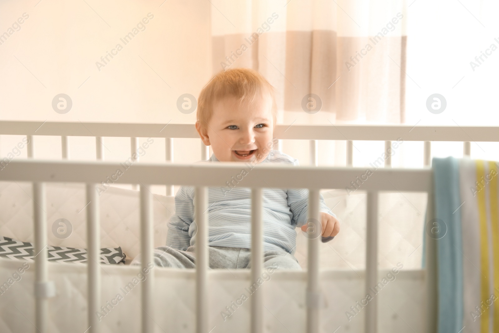 Photo of Cute little baby in crib at home