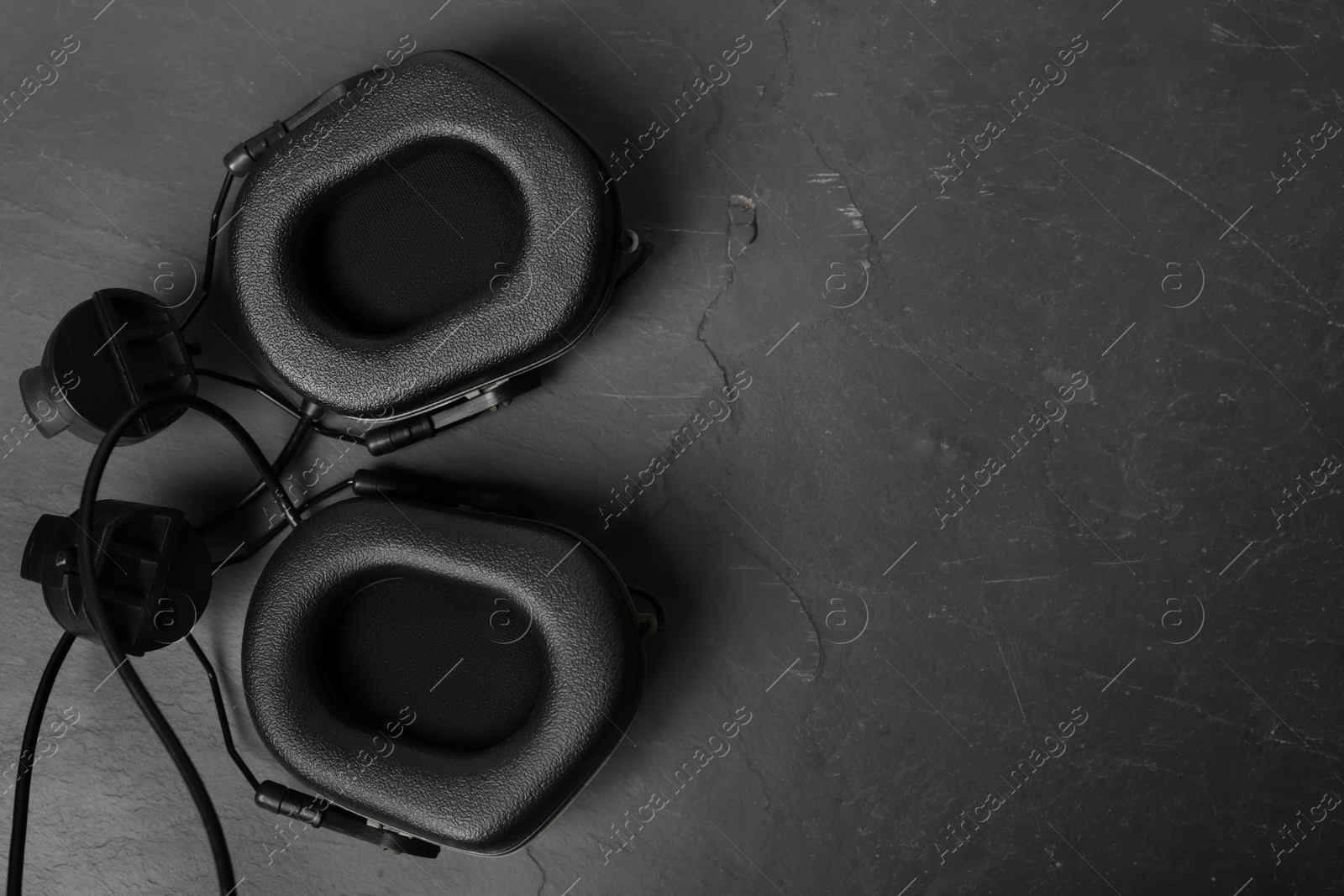 Photo of Tactical headphones on black background, flat lay with space for text. Military training equipment