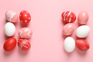 Photo of Flat lay composition with painted Easter eggs on color background, space for text