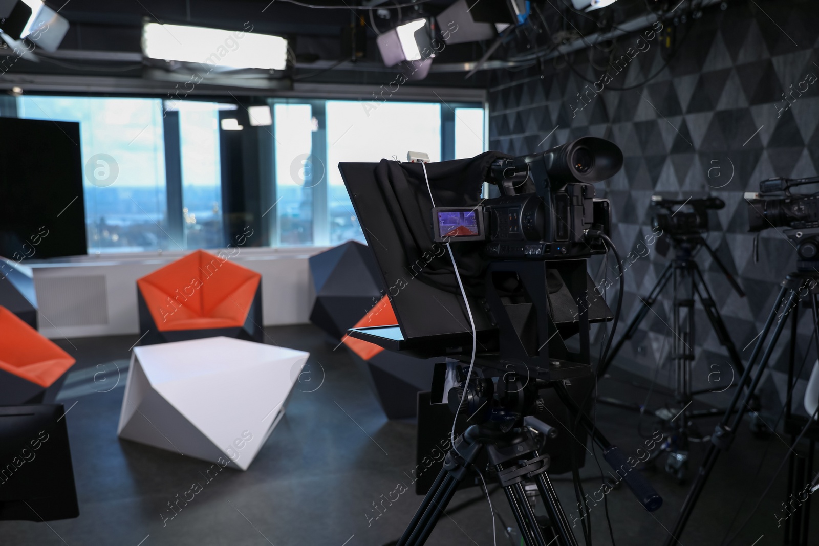 Photo of Modern video recording studio with professional equipment, focus on camera