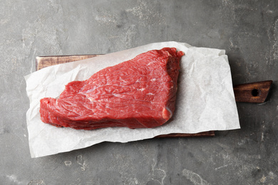 Fresh raw beef cut on grey table, top view