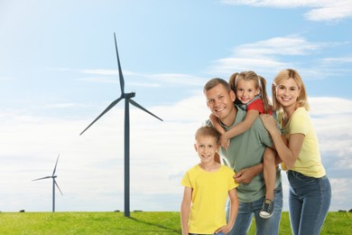 Image of Happy family with children and view of wind energy turbines