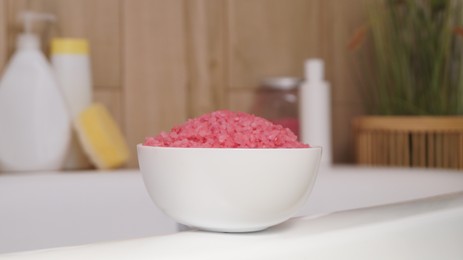 Bowl with sea salt on white bath