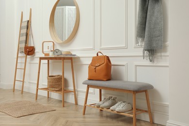 Photo of Hallway interior with stylish furniture, clothes and accessories