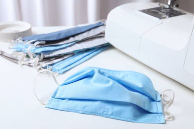 Handmade protective mask on white table. Sewing idea