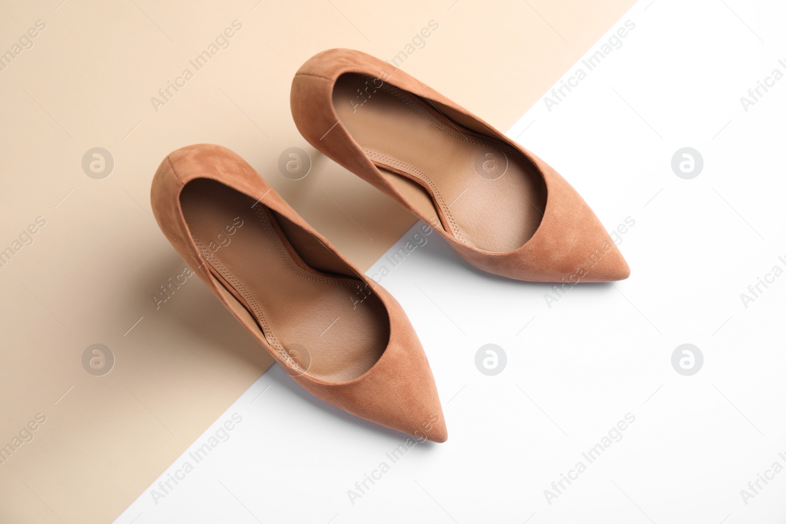 Photo of Pair of beautiful shoes on color background, top view