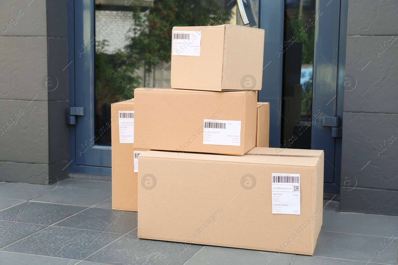 Photo of Stack of parcel boxes on floor near entrance