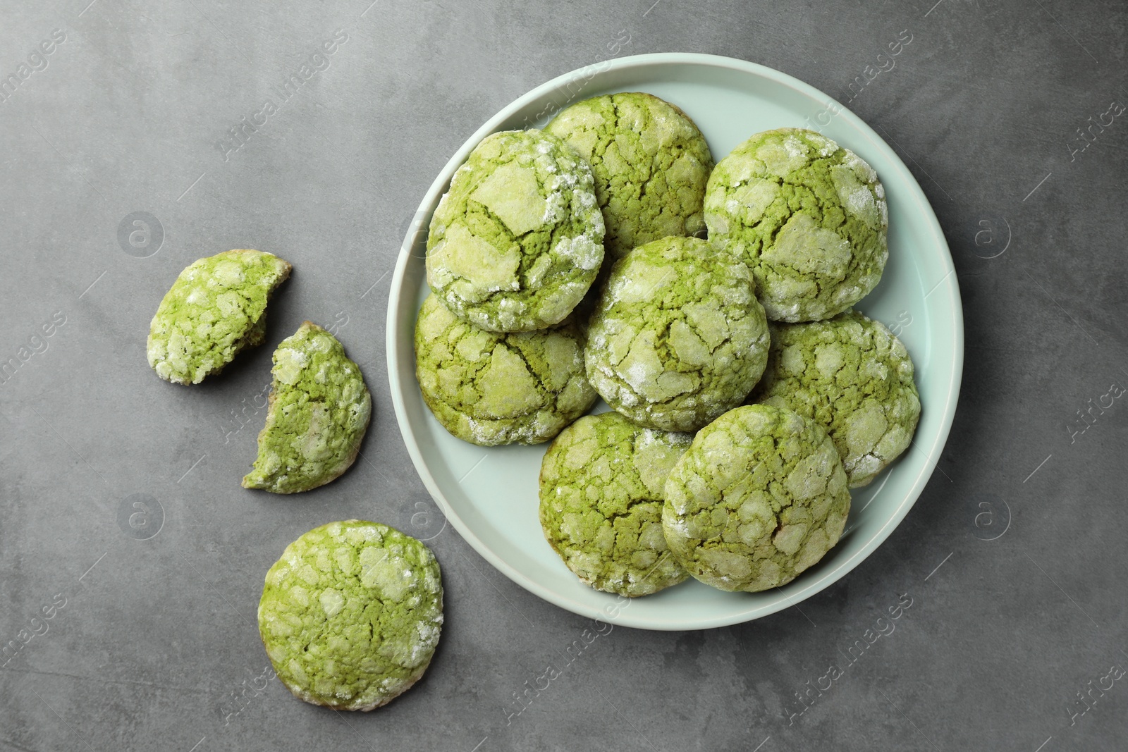 Photo of Plate with tasty matcha cookies on grey table, flat lay