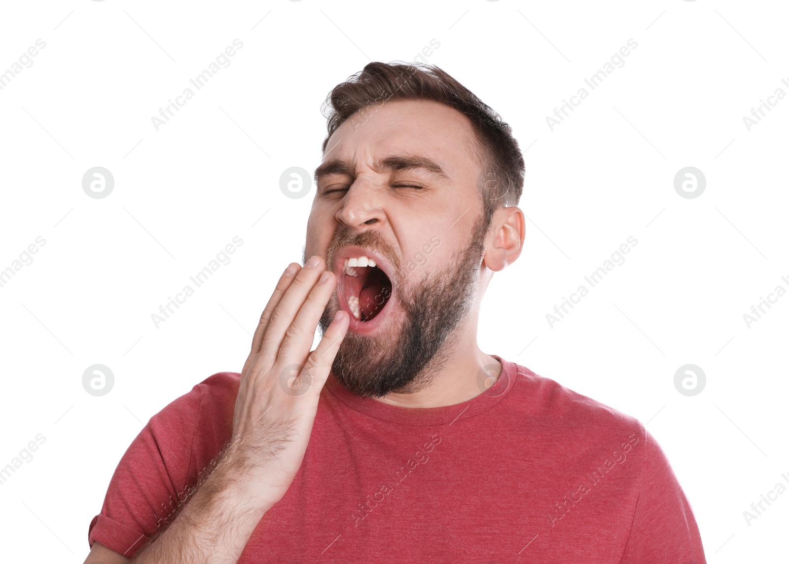 Photo of Sleepy young man yawning on white background