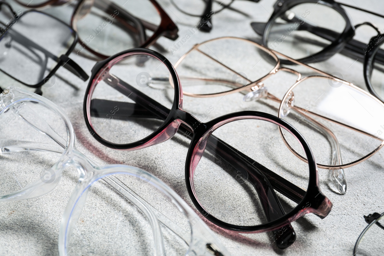 Photo of Many different glasses on light grey background, closeup