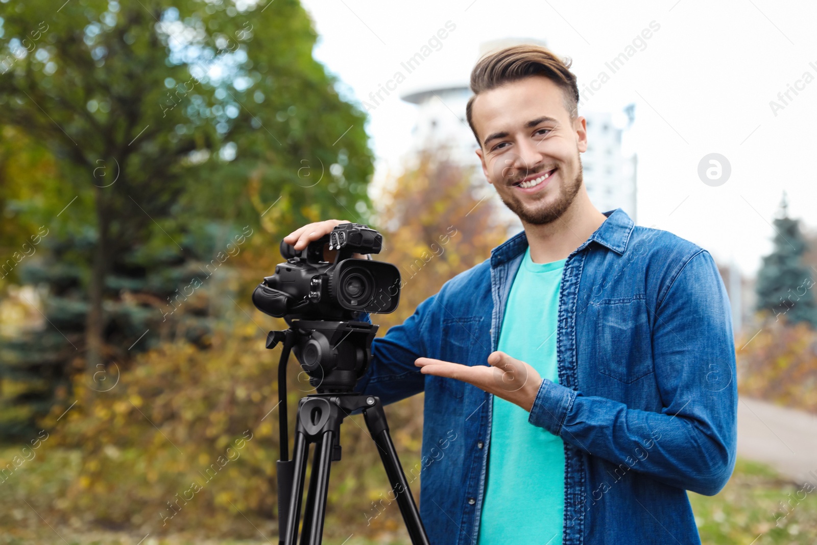 Photo of Video operator with camera working in park