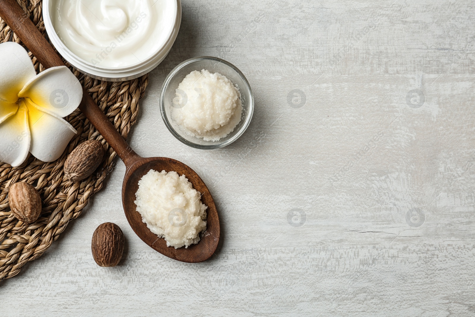 Photo of Flat lay composition with Shea butter, nuts and space for text on light background