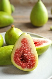 Plate with fresh ripe figs on table. Tropical fruit